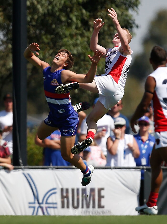 AFL 2016 NAB Challenge - Western Bulldogs v Melbourne MELBOURNE, AUSTRALIA - MARCH 6: Clayton Oliver of the Demons takes a spectacular mark over Josh Dunkley of the Bulldogs during the 2016 NAB Challenge match between the Western Bulldogs and the Melbourne Demons at Highgate Recreational Reserve, Craigieburn on March 6, 2016. (Photo by Michael Willson/AFL Media)